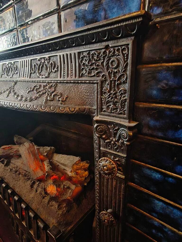 The ornate original cast-iron fireplace