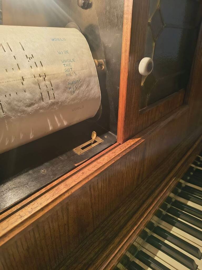The antique player piano, roll and keys