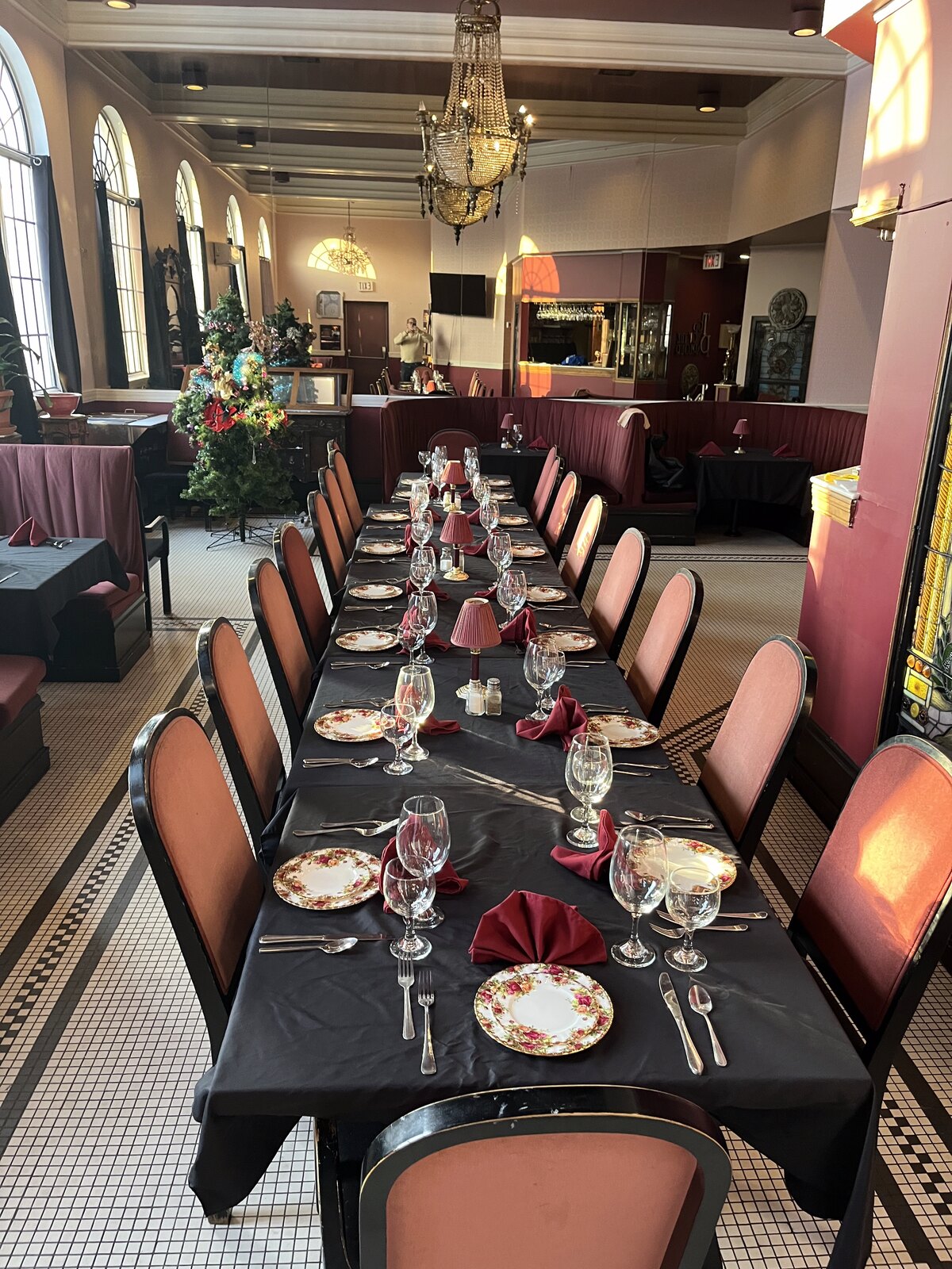 The Top of the Parlour dining room with arched windows and chandeliers